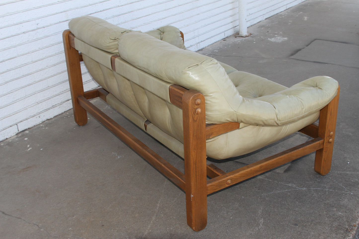 Mid Century teak loveseat. This love seat sofa exudes timeless appeal, making it a must-have for any Mid-Century enthusiast.