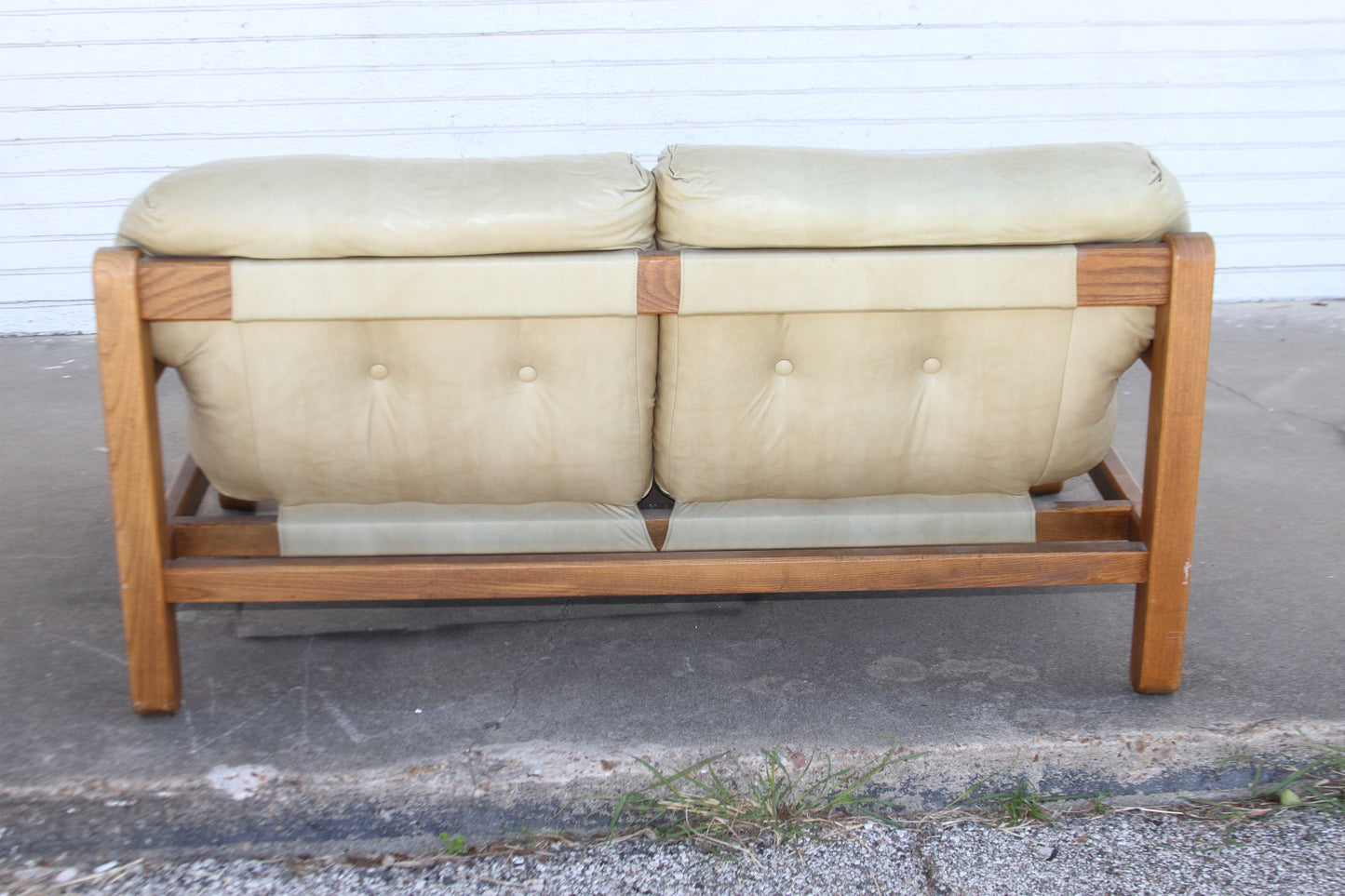 vintage charm and modern style with this exceptional Mid Century teak loveseat. This loveseat is a rare find among couches for sale.