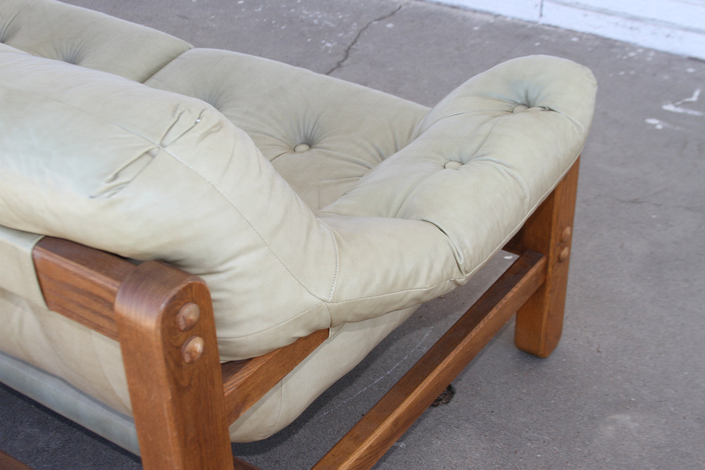 Mid Century teak loveseat. Expertly crafted for lasting beauty, this loveseat sofa is a rare gem for any Mid-Century enthusiast among couches for sale.