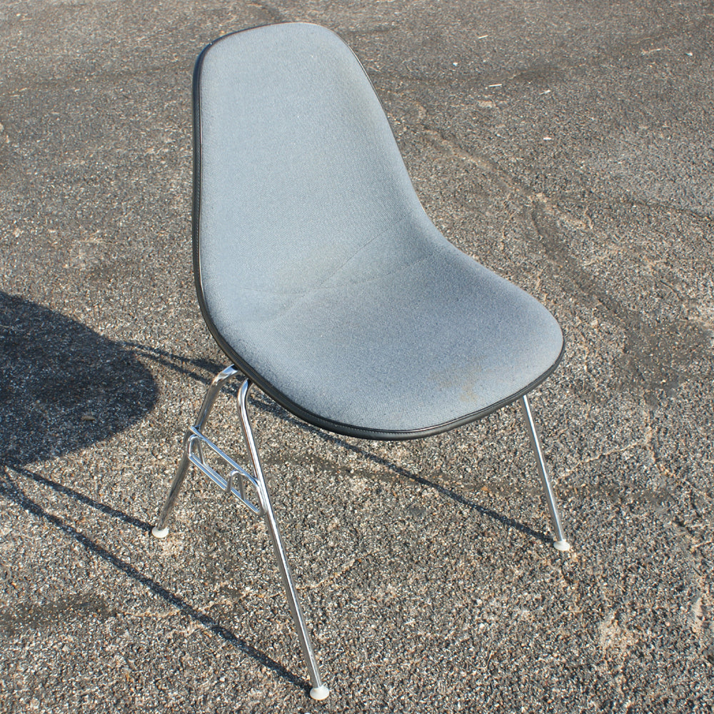 Light Blue in color Herman Miller Eames Upholstered Fiberglass Shell Chair. Crafted with a molded fiberglass shell and thoughtfully upholstered for comfort, this chair embodies the essence of iconic design. 