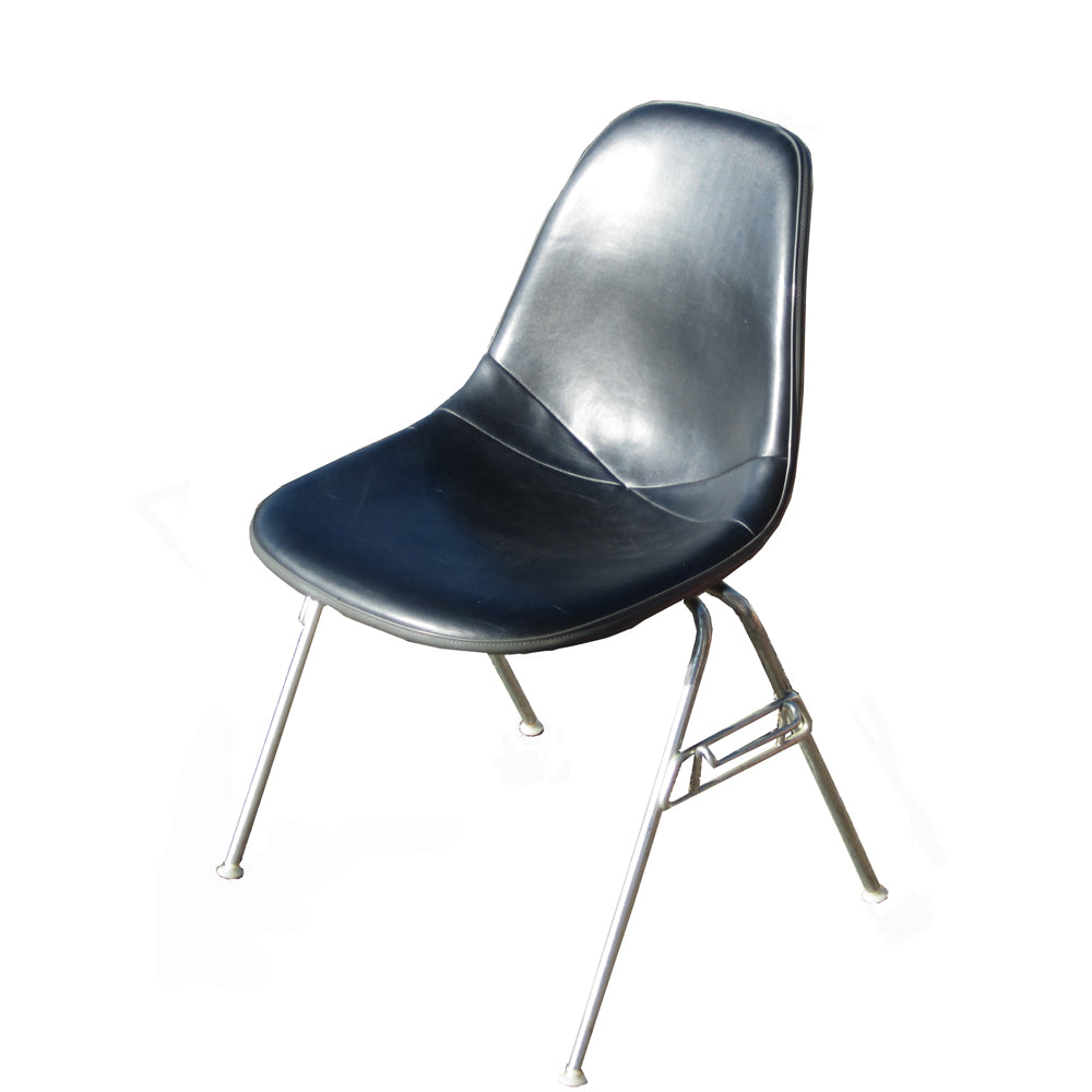 Black in color  Charles and Ray Eames with the Herman Miller Eames Upholstered Fiberglass Shell Chair. Featuring a sculptural fiberglass shell and customizable upholstery, this chair redefines comfort and style.