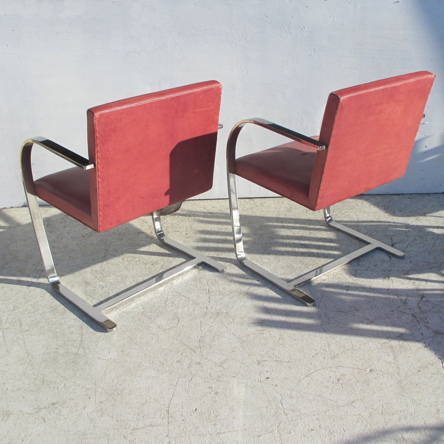 Brno Chairs, crafted with a stainless steel frame, cushioned seat, and vibrant red upholstery for a contemporary look.